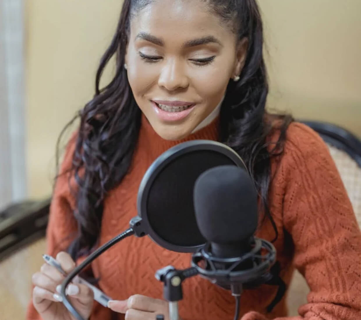 A woman recording in a studio
